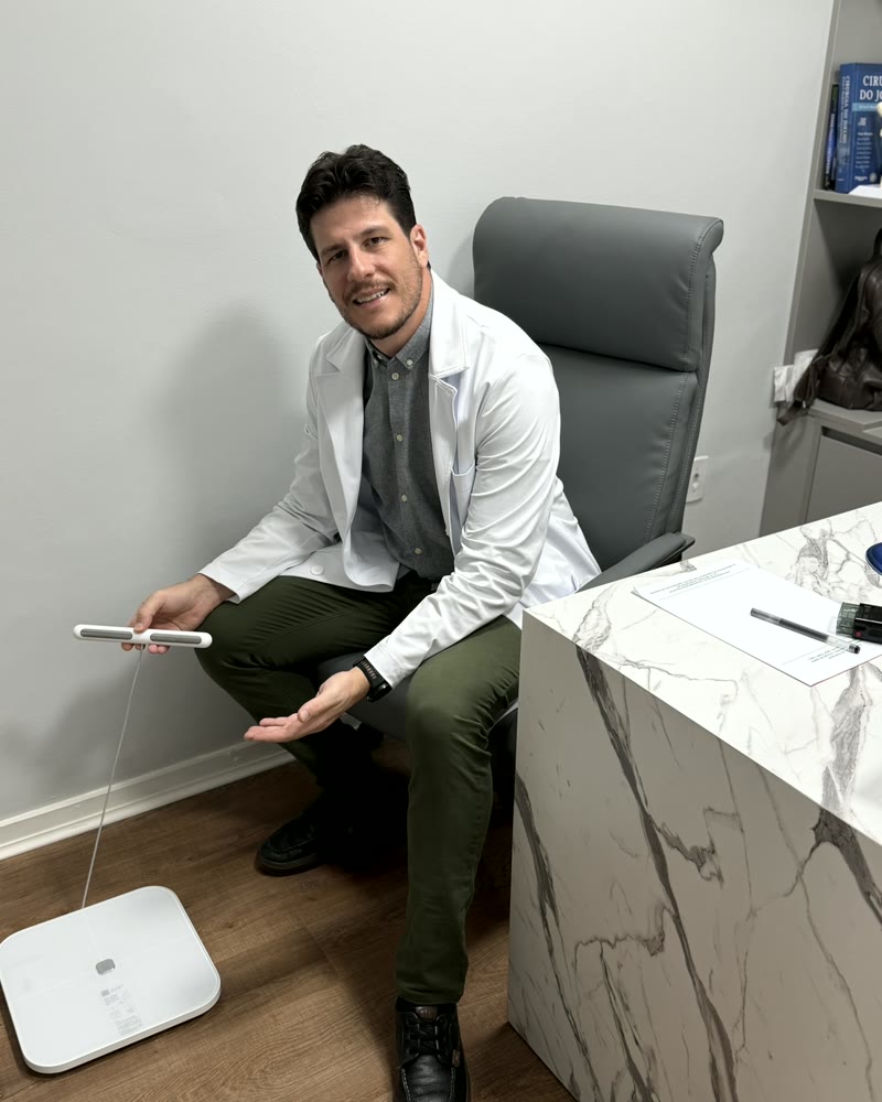 Dr. Rúbio Arruda com o aparelho de bioimpedância no consultório em Copacabana